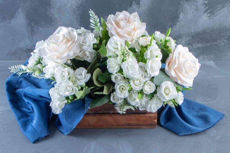 A bunch of white fresh sympathy flowers with greens to support someone in grieves or recovery.